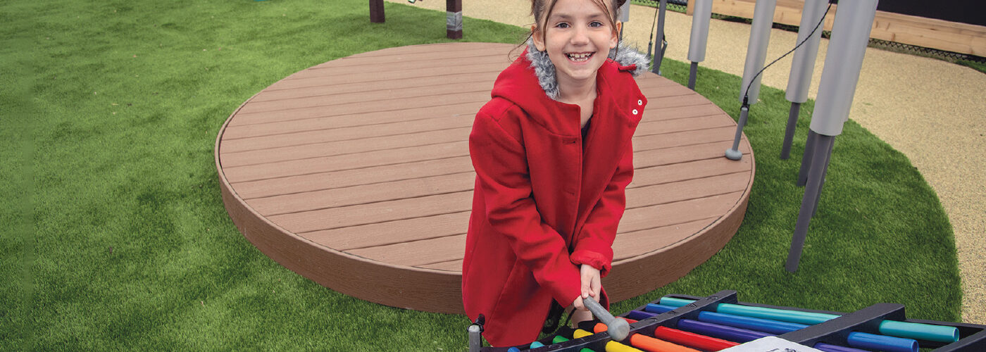 Girl playing on outdoor equipment