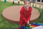 Girl playing on outdoor equipment