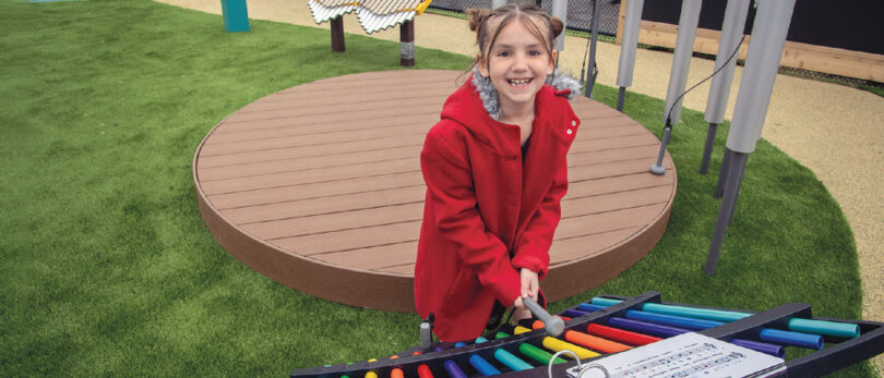 Girl playing on outdoor equipment