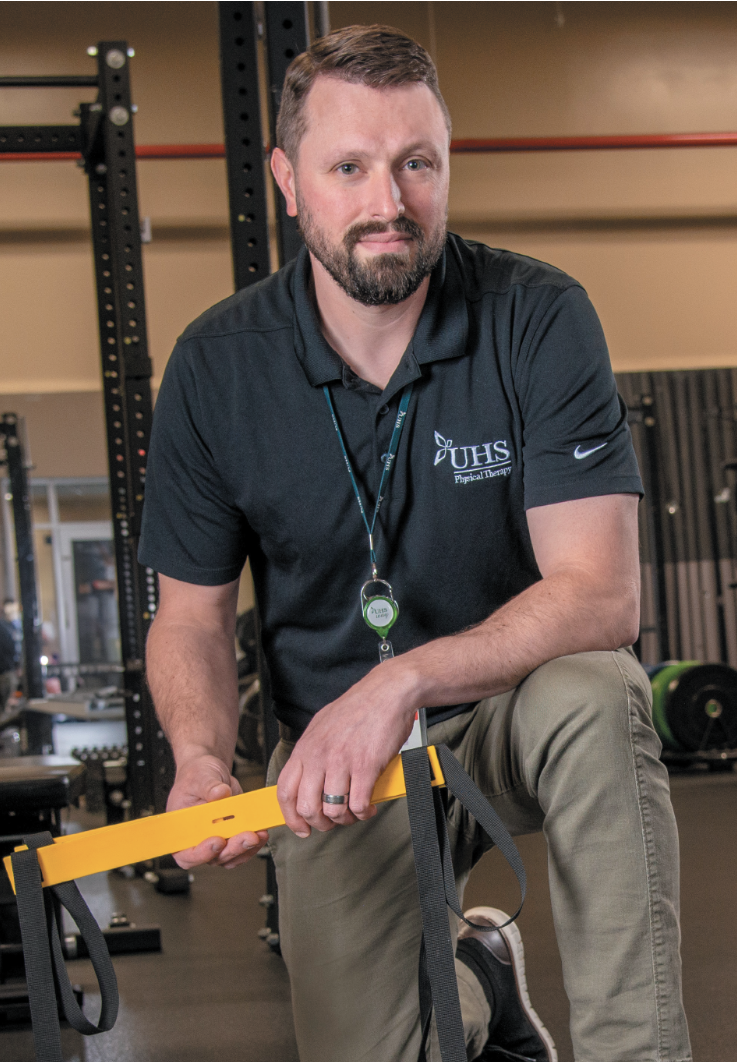 man kneeling with exercise equipment