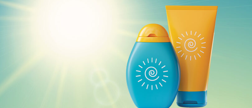 sunscreen products in front of glaring, hot sun