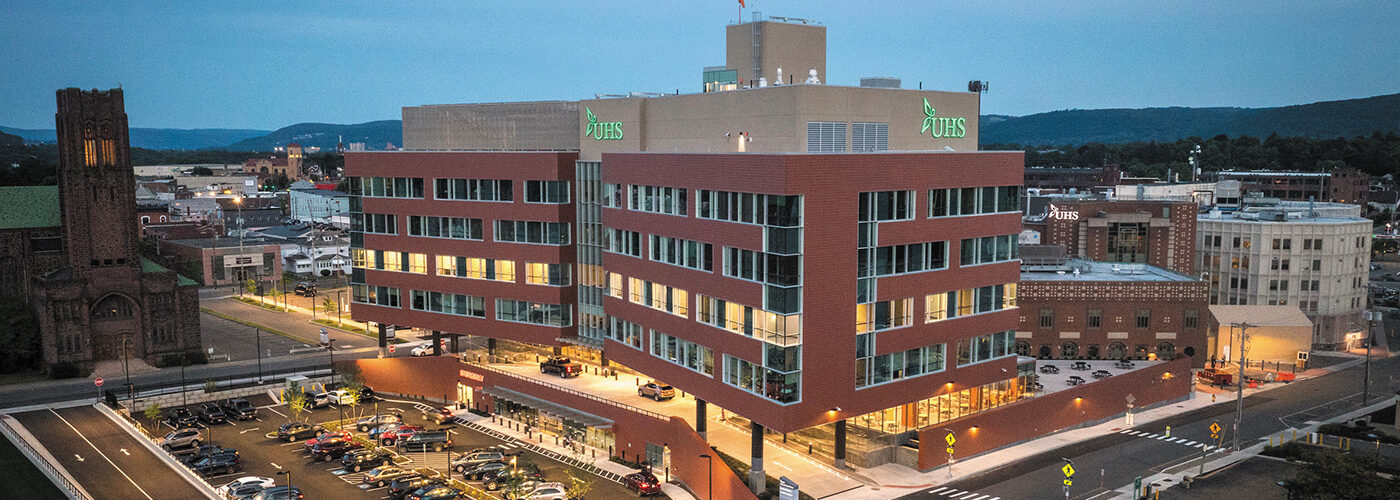 red brick building with lights on at dusk