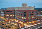 red brick building with lights on at dusk