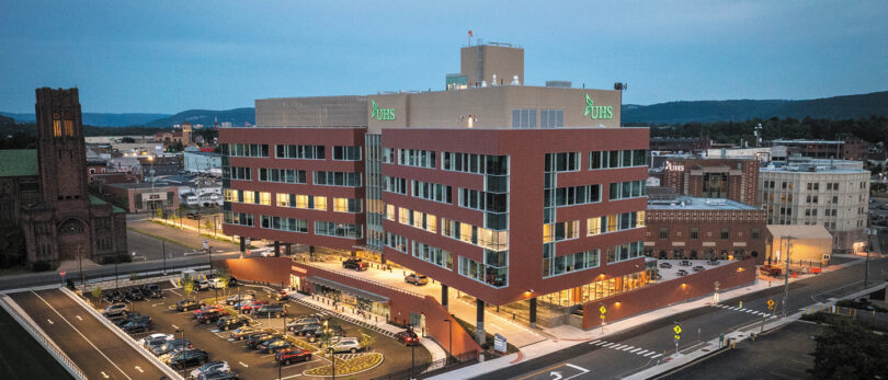 red brick building with lights on at dusk