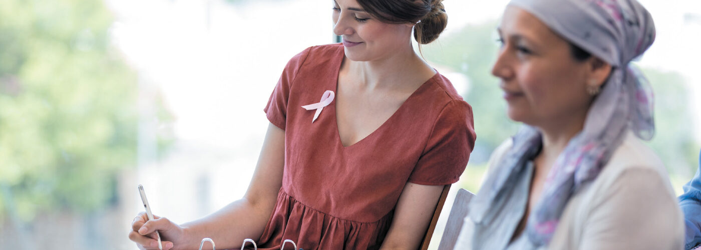 Woman sitting with cancer patient