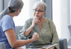 Older female patient looking thoughtfully at her doctor.