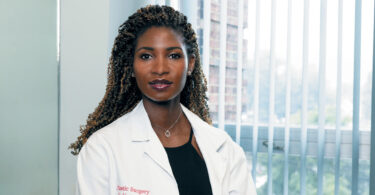 Female doctor looking straight into the camera.